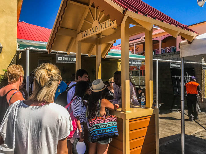 Visitors cue up at the Taxi & Tour kiosk for information on island tours, beach transfer and other services.