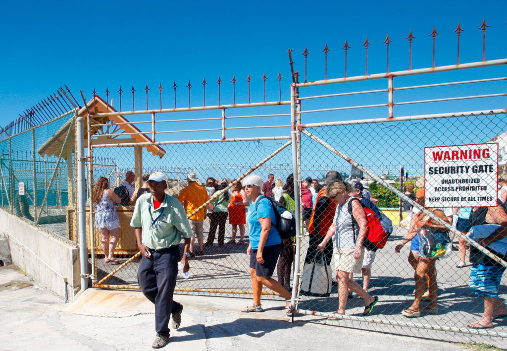 Cruise ship passengers following their taxi guide after experiencing a smoother transition from their ship to a tour of the island via the new kiosk distributing system